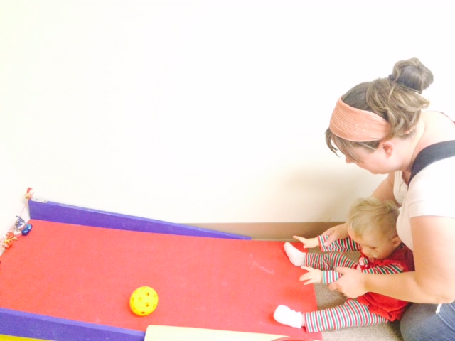 A mother playing with her baby in the popcorn room